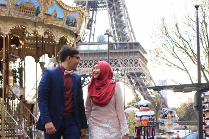 a man and a woman standing in front of a building