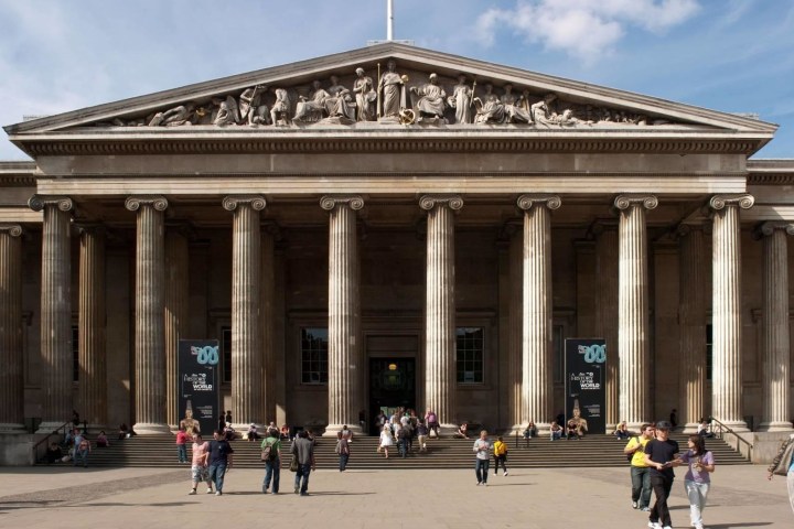 a group of people walking in front of British Museum