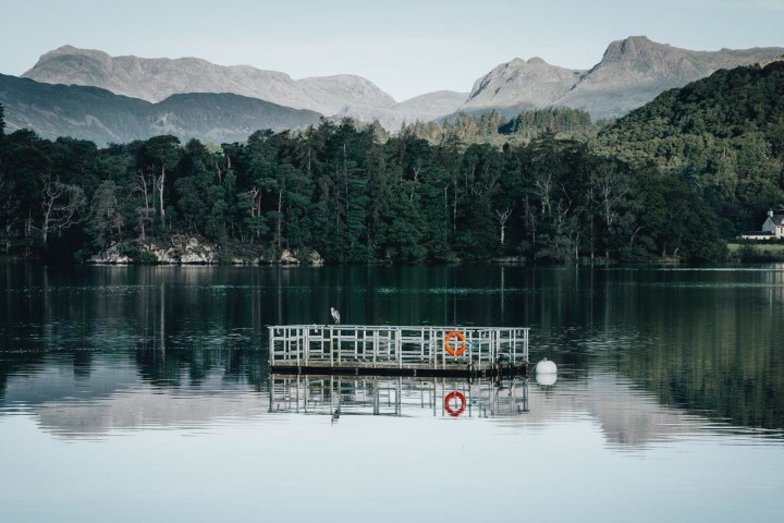 a large body of water with a mountain in the background