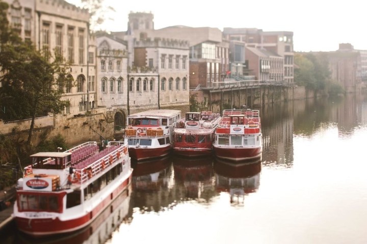 a small boat in a body of water with a city in the background