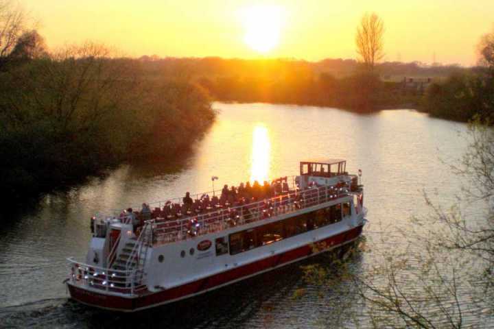 a boat traveling along a river next to a body of water