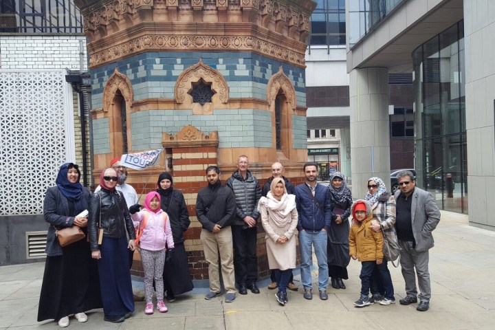 a group of people standing in front of a building