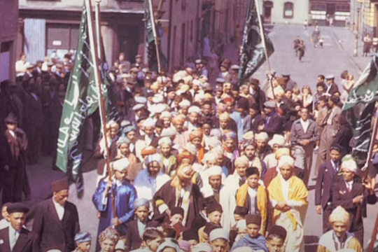 a group of people standing in front of a crowd posing for the camera